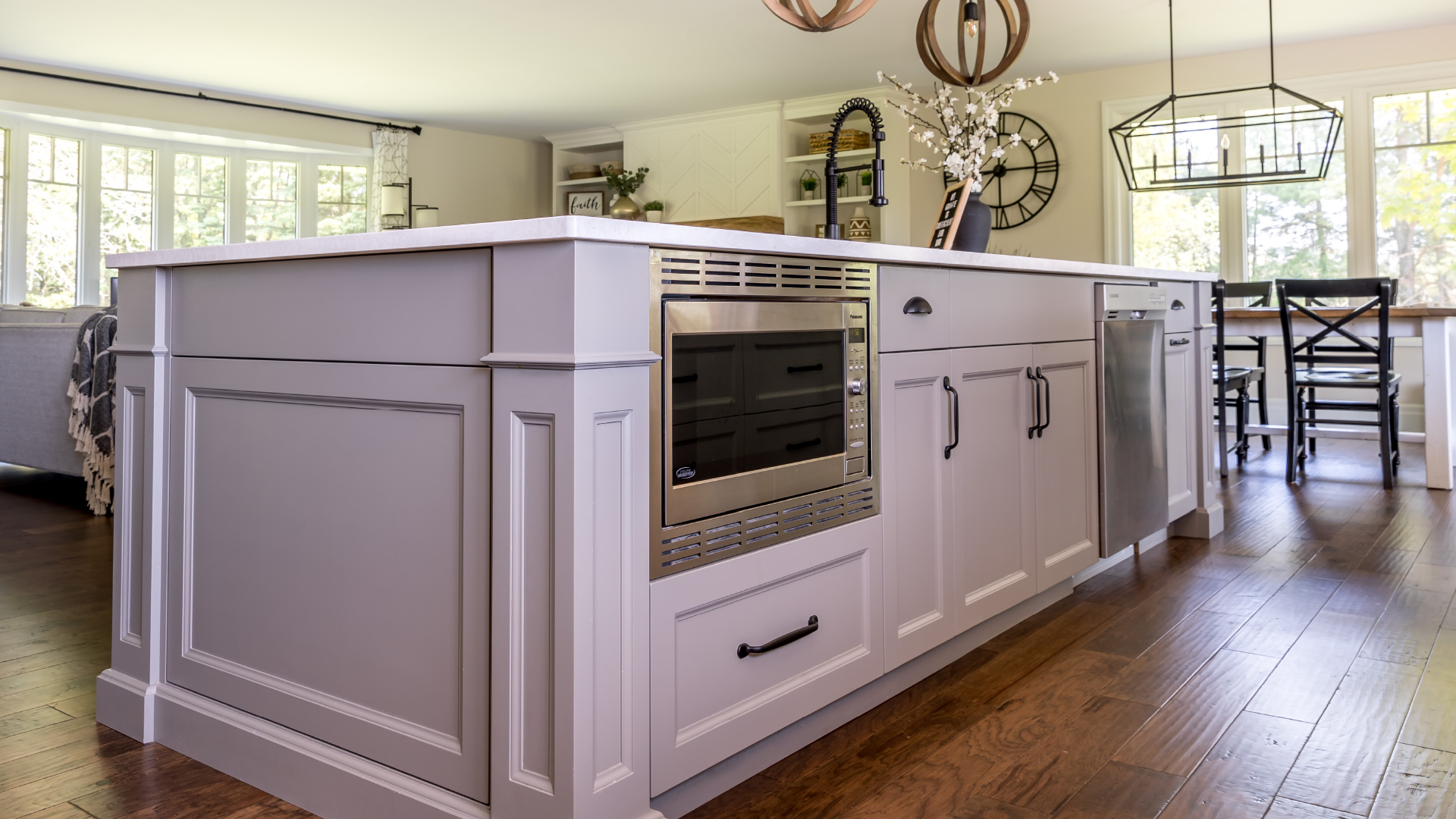 A large custom kitchen island with a built in microwave